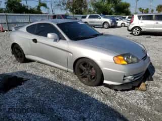 2004 Hyundai Tiburon GT с VIN KMHHN65F94U153507, выставлен на аукционе Copart как лот 66108085 с пробегом 113 413 миль миль и Списание • Salvage title. История ставок и продаж доступна на DreamBid. Изображение 4.