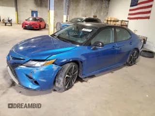 ✅ 2019 Toyota Camry XLE • VIN: 4T1BZ1HK1KU023787 • Лот: 92282855. Опубликован ранее на Copart с пробегом 99 980 миль. Бесплатный доступ к архиву аукционных продаж из США и подробный отчёт об истории автомобиля на DreamBid. Изображение 1.