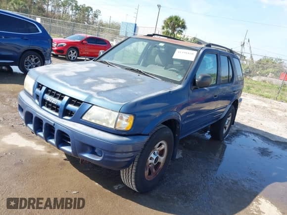 ✅ 2004 Isuzu Rodeo S • VIN: 4S2CK58W944317209 • Lot: 41498160. Listed on IAAI with 114,764 mi. Free auction sales archive from the USA and detailed vehicle history report at DreamBid. Image 2.