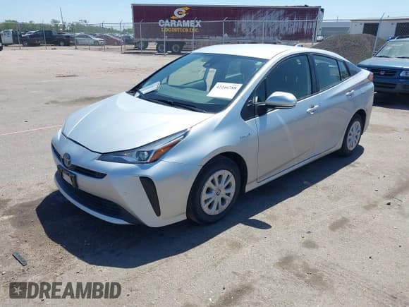 ✅ 2021 Toyota Prius L Eco • VIN: JTDKAMFU4M3148082 • Lot: 42246788. Listed on IAAI with 72,124 mi. Free auction sales archive from the USA and detailed vehicle history report at DreamBid. Image 2.