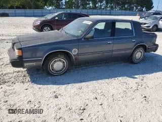 ✅ 1989 Dodge Dynasty • VIN: 1B3BC4632KD615753 • Lot: 64080955. Listed on Copart with 54,020 mi. Free auction sales archive from the USA and detailed vehicle history report at DreamBid. Image 1.