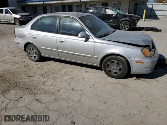 2005 Hyundai Accent GLS with VIN KMHCG45C75U638812, listed as a Copart auction lot 77968234 with 130,815 mi miles and Salvage title. Bid and sale history available at DreamBid. Image 4.