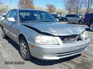 ✅ 2002 Kia Optima LX • VIN: KNAGD128X25180280 • Lot: 41967222. Wystawiony na IAAI z przebiegiem 101 307 mil. Bezpłatny archiwum sprzedaży aukcyjnych z USA i szczegółowy raport historii pojazdu na DreamBid. Zdjęcie 1.
