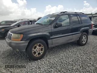 ✅ 1999 Jeep Grand Cherokee Laredo • VIN: 1J4G258S4XC577449 • Lot: 66556115. Listed on Copart with 220,256 mi. Free auction sales archive from the USA and detailed vehicle history report at DreamBid. Image 1.