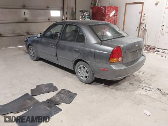 2004 Hyundai Accent GL z VIN KMHCG45C44U528783, wystawiony jako IAAI lot #41535104 z przebiegiem Nie podano mil oraz . Historia ofert i sprzedaży dostępna na DreamBid. Obrazek 3.
