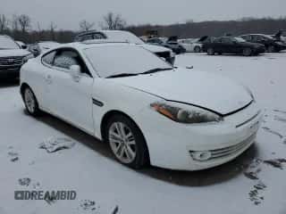 2007 Hyundai Tiburon GS z VIN KMHHM66D67U254976, wystawiony jako Copart lot #87434194 z przebiegiem Nie podano mil oraz Czysty tytuł • Clean title. Historia ofert i sprzedaży dostępna na DreamBid. Obrazek 4.