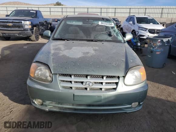 2003 Hyundai Accent GL z VIN KMHCG35CX3U242848, wystawiony jako Copart lot #86558394 z przebiegiem 56 248 mil mil oraz Szkoda całkowita • Salvage title. Historia ofert i sprzedaży dostępna na DreamBid. Obrazek 5.