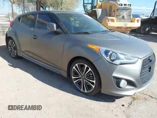 2014 Hyundai Veloster Turbo z VIN KMHTC6AE0EU184269, wystawiony jako IAAI lot #43241844 z przebiegiem 60 668 mil mil oraz . Historia ofert i sprzedaży dostępna na DreamBid. Obrazek 1.