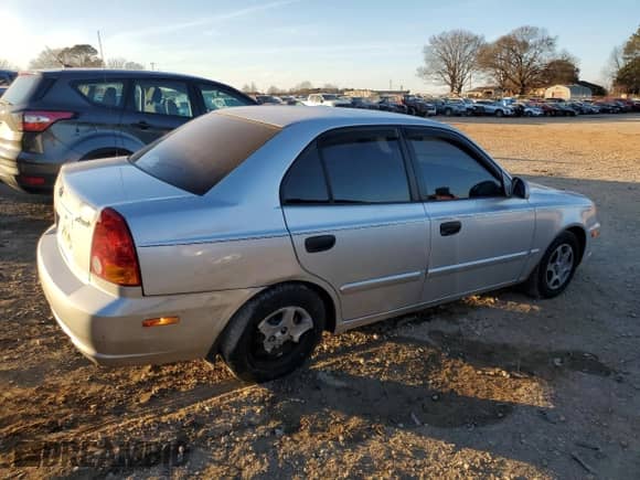 2003 Hyundai Accent GL with VIN KMHCG45C93U496038, listed as a Copart auction lot 87260904 with 104,251 mi miles and Salvage title. Bid and sale history available at DreamBid. Image 3.