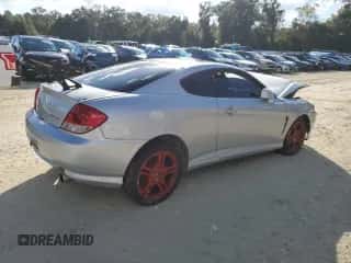 2006 Hyundai Tiburon GT z VIN KMHHN65F96U224661, wystawiony jako Copart lot #76643653 z przebiegiem 200 436 mil mil oraz Szkoda całkowita • Salvage title. Historia ofert i sprzedaży dostępna na DreamBid. Obrazek 3.