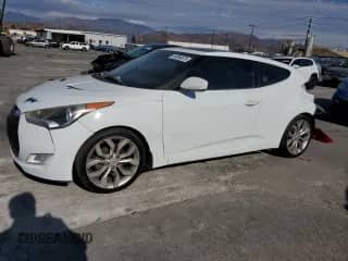 2015 Hyundai Veloster z VIN KMHTC6AD5FU225164, wystawiony jako Copart lot #84994875 z przebiegiem 185 494 mil mil oraz Szkoda całkowita • Salvage title. Historia ofert i sprzedaży dostępna na DreamBid. Obrazek 1.