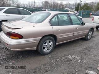 ✅ 1999 Pontiac Bonneville SE • VIN: 1G2HX52K4XH240517 • Lot: 41130986. Wystawiony na IAAI z przebiegiem 106 294 mil. Bezpłatny archiwum sprzedaży aukcyjnych z USA i szczegółowy raport historii pojazdu na DreamBid. Zdjęcie 4.