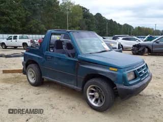 1998 Chevrolet Tracker z VIN 2CNBE1865W6925992, wystawiony jako IAAI lot #43328061 z przebiegiem 98 404 mil mil oraz . Historia ofert i sprzedaży dostępna na DreamBid. Obrazek 1.