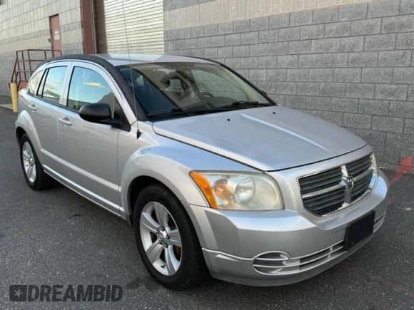 2010 Dodge Caliber SXT with VIN 1B3CB4HA1AD579409, listed as a Copart auction lot 84451614 with 100,311 mi miles and Clean title. Bid and sale history available at DreamBid. Image 1.