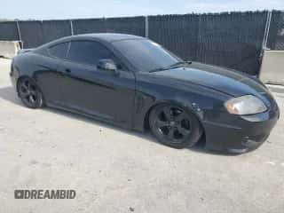 2006 Hyundai Tiburon GS с VIN KMHHM65D06U191468, выставлен на аукционе Copart как лот 70183555 с пробегом 195 594 миль миль и Списание • Salvage title. История ставок и продаж доступна на DreamBid. Изображение 4.