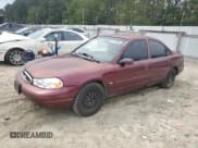 ✅ 1999 Ford Contour LX • VIN: 1FAFP653XXK106939 • Lot: 84759455. Listed on Copart with 233,891 mi. Free auction sales archive from the USA and detailed vehicle history report at DreamBid. Image 1.