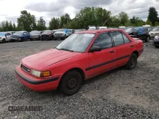 ✅ 1991 Mazda Protege DX • VIN: JM1BG2242M0264276 • Lot: 67682584. Wystawiony na Copart z przebiegiem 189 297 mil. Bezpłatny archiwum sprzedaży aukcyjnych z USA i szczegółowy raport historii pojazdu na DreamBid. Zdjęcie 1.