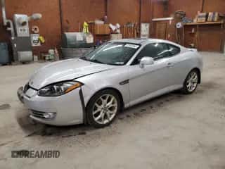 2007 Hyundai Tiburon GT z VIN KMHHN66F47U251850, wystawiony jako Copart lot #51900565 z przebiegiem 130 388 mil mil oraz Szkoda całkowita • Salvage title. Historia ofert i sprzedaży dostępna na DreamBid. Obrazek 1.
