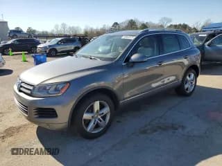 ✅ 2013 Volkswagen Touareg Exec • VIN: WVGEF9BP8DD010465 • Lot: 48802075. Listed on Copart with 149,491 mi. Free auction sales archive from the USA and detailed vehicle history report at DreamBid. Image 1.
