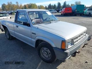 ✅ 1986 Mazda B-Series SE5 • VIN: JM2UF1117G0616409 • Lot: 43479694. Listed on IAAI with 80,733 mi. Free auction sales archive from the USA and detailed vehicle history report at DreamBid. Image 1.