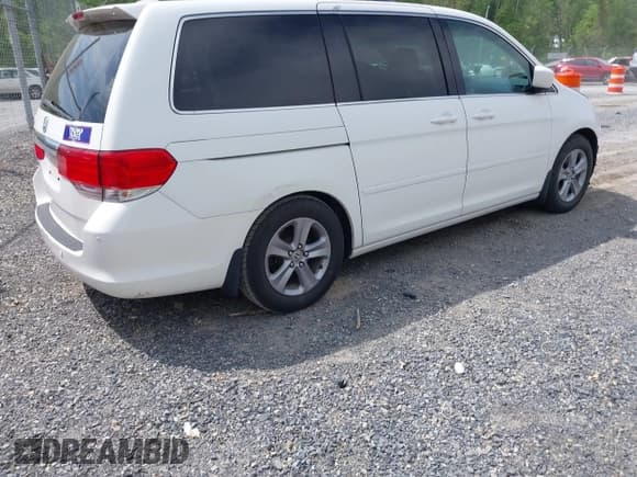✅ 2010 Honda Odyssey Touring • VIN: 5FNRL3H90AB039449 • Lot: 42032203. Listed on IAAI with 128,265 mi. Free auction sales archive from the USA and detailed vehicle history report at DreamBid. Image 4.