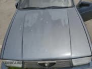 ✅ 1988 Alfa Romeo Milano • VIN: ZARDB1407J1250591 • Lot: 56344445. Listed on Copart with 7,703 mi. Free auction sales archive from the USA and detailed vehicle history report at DreamBid. Image 11.