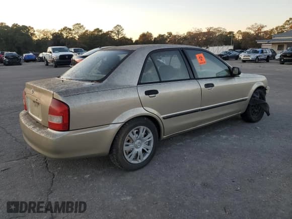 ✅ 2003 Mazda Protege DX • VIN: JM1BJ225230154255 • Лот: 84426944. Опубликован ранее на Copart с пробегом Не указан. Бесплатный доступ к архиву аукционных продаж из США и подробный отчёт об истории автомобиля на DreamBid. Изображение 3.