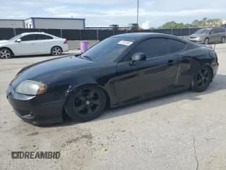 ✅ 2006 Hyundai Tiburon GS • VIN: KMHHM65D06U191468 • Лот: 70183555. Опубликован ранее на Copart с пробегом 195 594 миль. Бесплатный доступ к архиву аукционных продаж из США и подробный отчёт об истории автомобиля на DreamBid. Изображение 1.