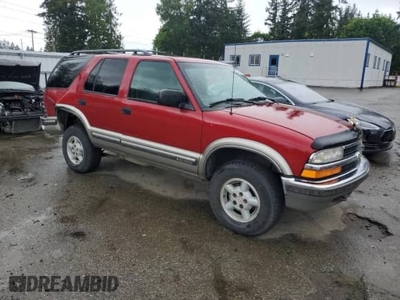 1999 Chevrolet Blazer LT with VIN 1GNDT13W7X2243230, listed as a Copart auction lot 57298805 with 230,907 mi miles and Salvage title. Bid and sale history available at DreamBid. Image 4.