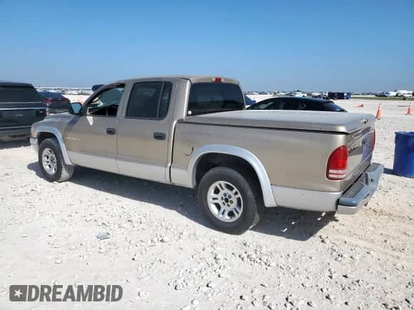 2002 Dodge Dakota SLT z VIN 1B7HL48XX2S693282, wystawiony jako Copart lot #66738085 z przebiegiem 142 180 mil mil oraz Czysty tytuł • Clean title. Historia ofert i sprzedaży dostępna na DreamBid. Obrazek 2.