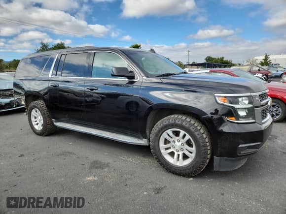 2015 Chevrolet Suburban LT with VIN 1GNSKJKC6FR660894, listed as a Copart auction lot 82732065 with 47,176 mi miles and Salvage title. Bid and sale history available at DreamBid. Image 4.