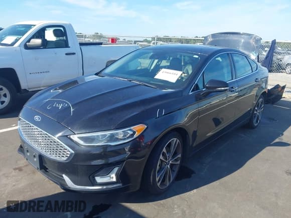 ✅ 2019 Ford Fusion Titanium • VIN: 3FA6P0D98KR137890 • Lot: 43066104. Listed on IAAI with 122,462 mi. Free auction sales archive from the USA and detailed vehicle history report at DreamBid. Image 2.