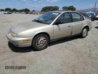 1998 Saturn SL with VIN 1G8ZK5272WZ276073, listed as a Copart auction lot 69880235 with 147,663 mi miles and Salvage title. Bid and sale history available at DreamBid. Image 1.