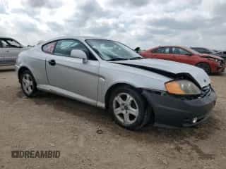 2003 Hyundai Tiburon z VIN KMHHM65D43U017995, wystawiony jako Copart lot #56498665 z przebiegiem 162 820 mil mil oraz Szkoda całkowita • Salvage title. Historia ofert i sprzedaży dostępna na DreamBid. Obrazek 4.