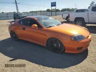 2006 Hyundai Tiburon GT z VIN KMHHN65FX6U221882, wystawiony jako Copart lot #57456825 z przebiegiem 203 312 mil mil oraz Szkoda całkowita • Salvage title. Historia ofert i sprzedaży dostępna na DreamBid. Obrazek 4.