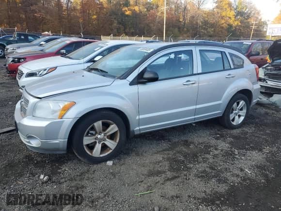 2011 Dodge Caliber Mainstreet with VIN 1B3CB3HA3BD123701, listed as a Copart auction lot 90858485 with 172,631 mi miles and Salvage title. Bid and sale history available at DreamBid. Image 1.