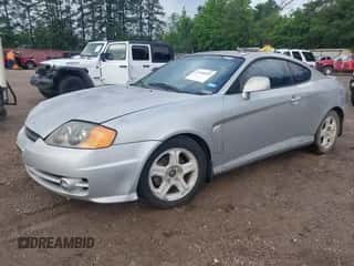 2003 Hyundai Tiburon GT z VIN KMHHN65F63U036899, wystawiony jako IAAI lot #42148935 z przebiegiem 203 485 mil mil oraz . Historia ofert i sprzedaży dostępna na DreamBid. Obrazek 2.