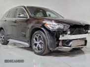 ✅ 2018 BMW X1 sDrive28i • VIN: WBXHU7C37J5L05511 • Lot: 95069525. Listed on Copart with 25,925 mi. Free auction sales archive from the USA and detailed vehicle history report at DreamBid. Image 1.