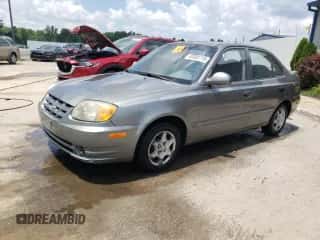 2005 Hyundai Accent GLS z VIN KMHCG45C45U645068, wystawiony jako Copart lot #63000715 z przebiegiem 205 762 mil mil oraz Nie do naprawy • Non repairable. Historia ofert i sprzedaży dostępna na DreamBid. Obrazek 1.