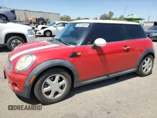2009 MINI Hardtop with VIN WMWMF33569TW74123, listed as a Copart auction lot 69144035 with 113,487 mi miles and Salvage title. Bid and sale history available at DreamBid. Image 1.