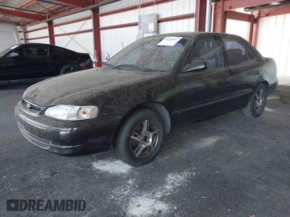 ✅ 1999 Toyota Corolla VE • VIN: 1NXBR12E0XZ197084 • Lot: 43220717. Listed on IAAI with 169,897 mi. Free auction sales archive from the USA and detailed vehicle history report at DreamBid. Image 2.
