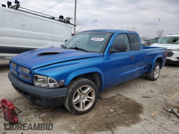 1999 Dodge Dakota Sport z VIN 1B7GL22Z7XS110023, wystawiony jako Copart lot #85889754 z przebiegiem Nie podano mil oraz Szkoda całkowita • Salvage title. Historia ofert i sprzedaży dostępna na DreamBid. Obrazek 1.