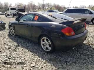 2003 Hyundai Tiburon GT z VIN KMHHN65F13U084620, wystawiony jako Copart lot #46880185 z przebiegiem Nie podano mil oraz Nie do naprawy • Non repairable. Historia ofert i sprzedaży dostępna na DreamBid. Obrazek 2.