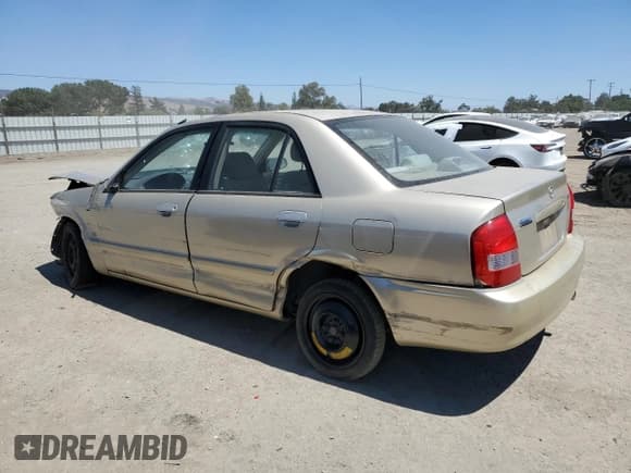 ✅ 2001 Mazda Protege LX • VIN: JM1BJ225610452367 • Lot: 65087615. Wystawiony na Copart z przebiegiem 212 110 mil. Bezpłatny archiwum sprzedaży aukcyjnych z USA i szczegółowy raport historii pojazdu na DreamBid. Zdjęcie 2.