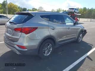 2018 Hyundai Santa Fe 2.4L z VIN 5NMZU3LBXJH098272, wystawiony jako IAAI lot #43375252 z przebiegiem 96 576 mil mil oraz . Historia ofert i sprzedaży dostępna na DreamBid. Obrazek 4.
