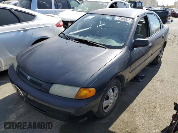✅ 1997 Mazda Protege DX • VIN: JM1BC1412V0157268 • Lot: 61380564. Listed on Copart with 85,356 mi. Free auction sales archive from the USA and detailed vehicle history report at DreamBid. Image 1.