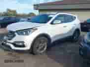 2018 Hyundai Santa Fe 2.4L z VIN 5NMZUDLB1JH097002, wystawiony jako IAAI lot #43473652 z przebiegiem 182 069 mil mil oraz . Historia ofert i sprzedaży dostępna na DreamBid. Obrazek 2.