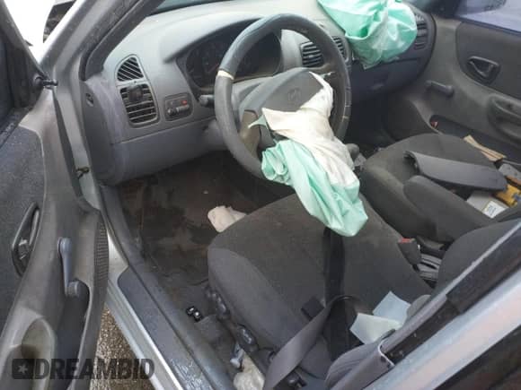 2002 Hyundai Accent GL with VIN KMHCG45C02U301443, listed as a Copart auction lot 80670164 with 124,163 mi miles and Salvage title. Bid and sale history available at DreamBid. Image 8.