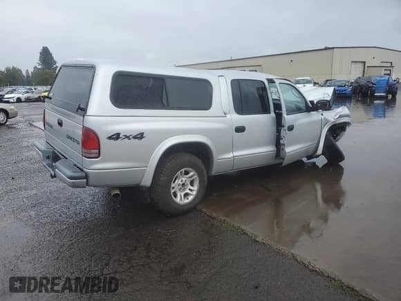 2003 Dodge Dakota Sport z VIN 1D7HG38N83S265442, wystawiony jako Copart lot #84969985 z przebiegiem Nie podano mil oraz Szkoda całkowita • Salvage title. Historia ofert i sprzedaży dostępna na DreamBid. Obrazek 3.
