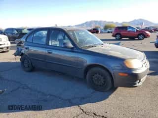 2005 Hyundai Accent GLS with VIN KMHCG45C95U665574, listed as a Copart auction lot 82603804 with 154,187 mi miles and Salvage title. Bid and sale history available at DreamBid. Image 4.